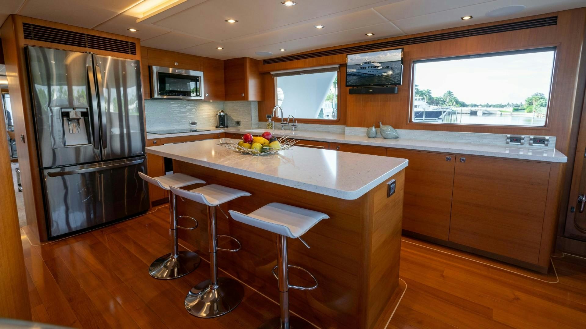 a kitchen with a bar and refrigerator aboard BLUE CHIP Yacht for Sale