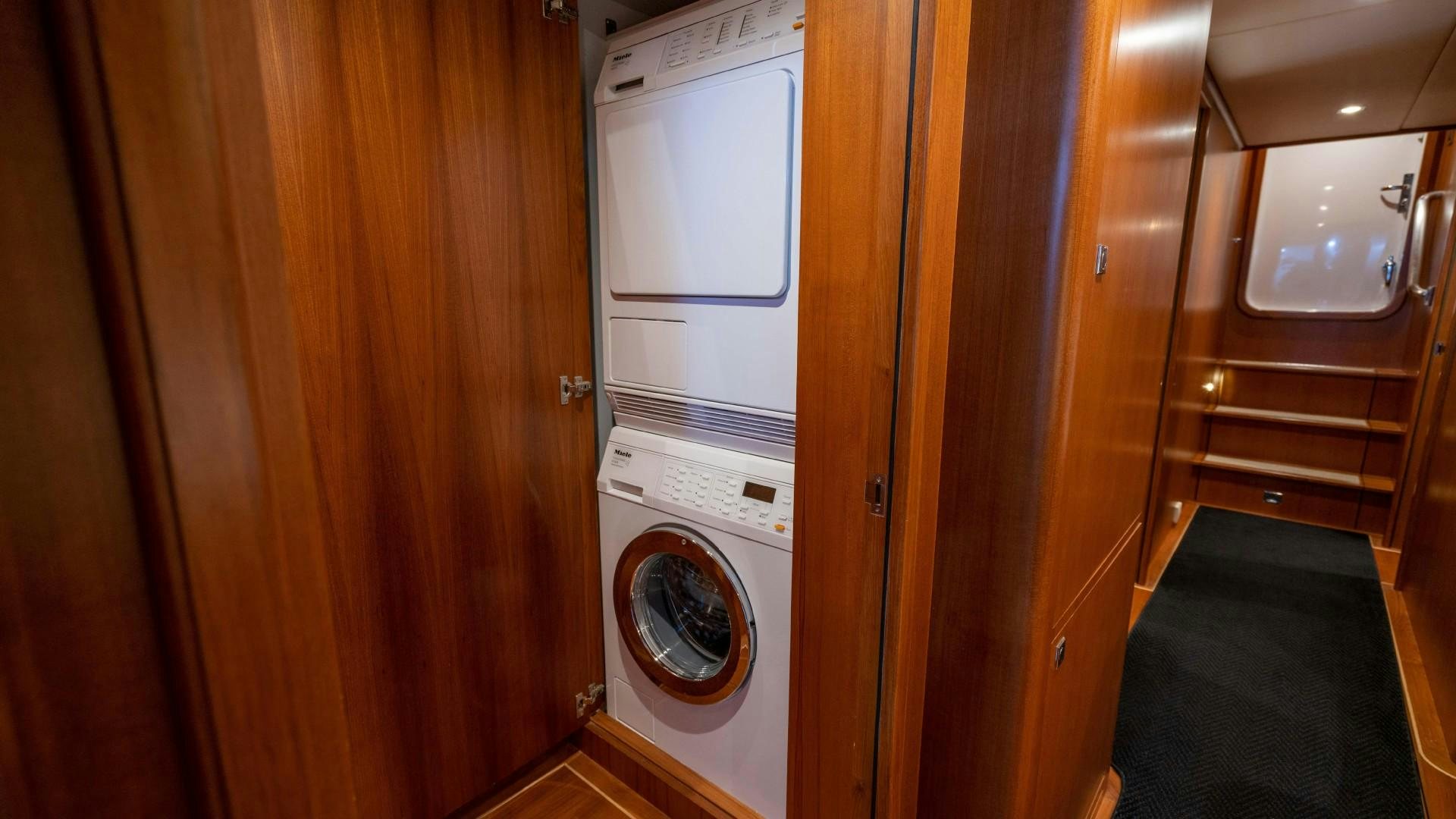 a room with a washing machine and a closet aboard BLUE CHIP Yacht for Sale
