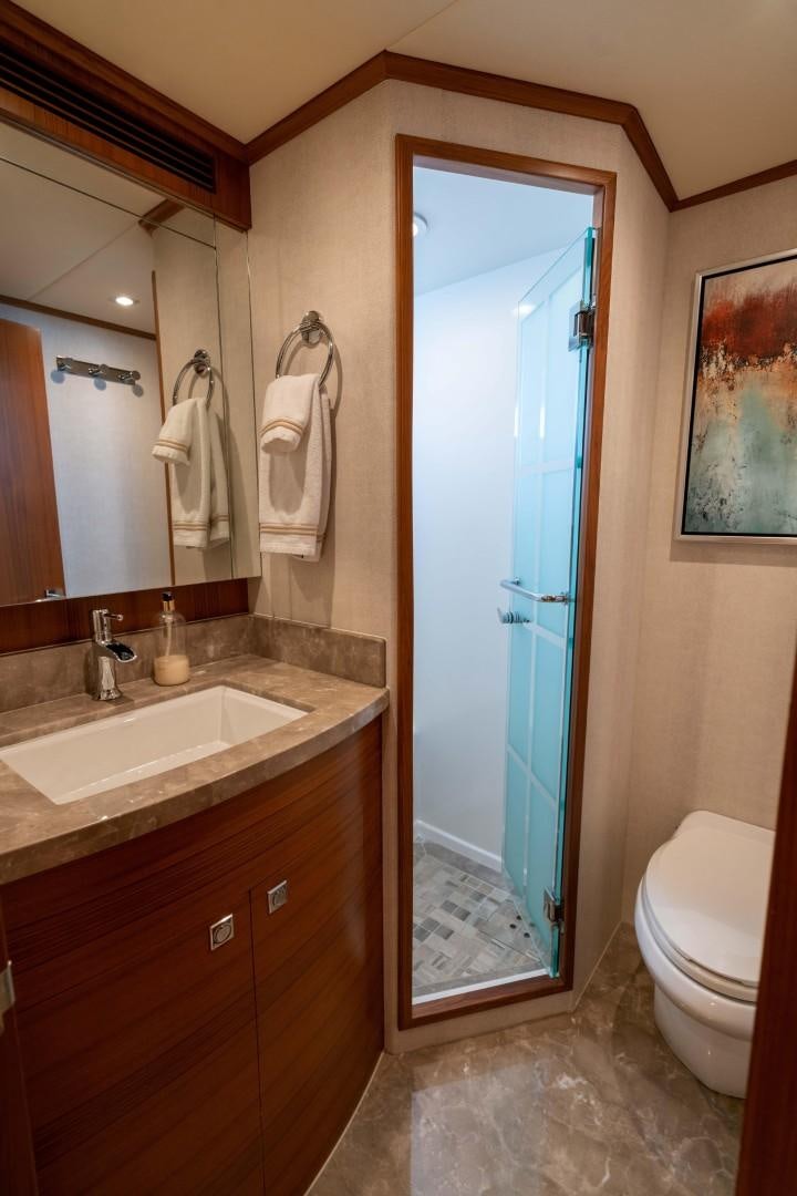 a bathroom with a glass shower door aboard BLUE CHIP Yacht for Sale