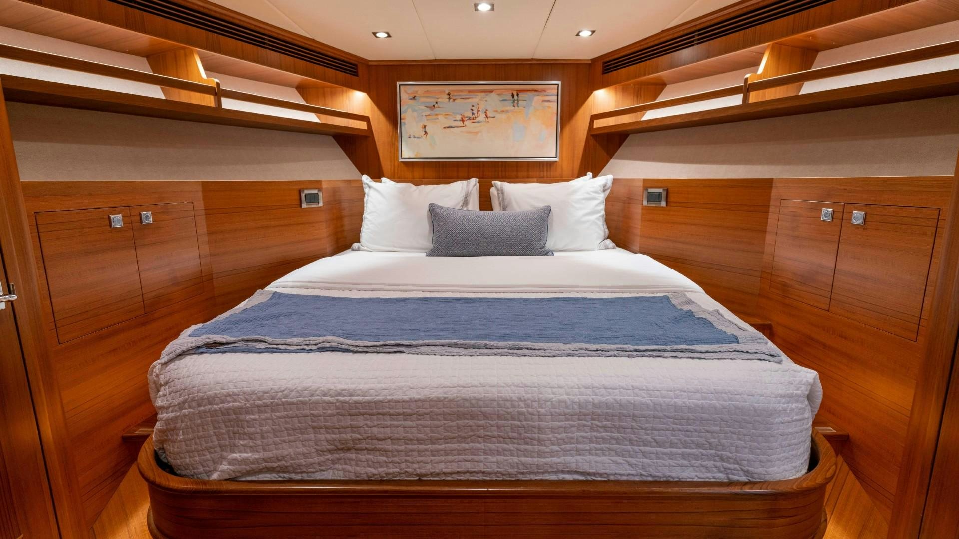 a bed with a blue sheet aboard BLUE CHIP Yacht for Sale