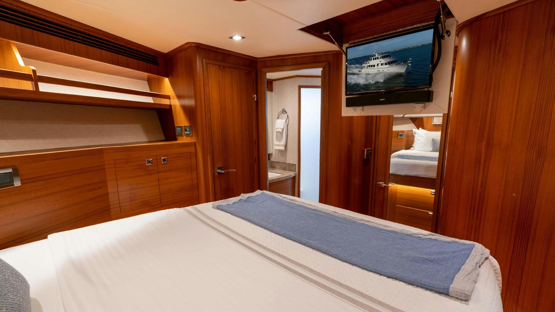 a hotel room with a television on the wall aboard BLUE CHIP Yacht for Sale