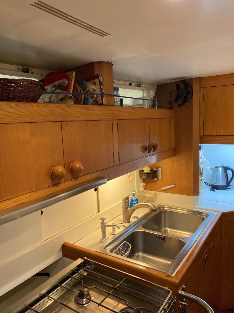 a kitchen with wooden cabinets aboard DANCES WITH WOLVES Yacht for Sale