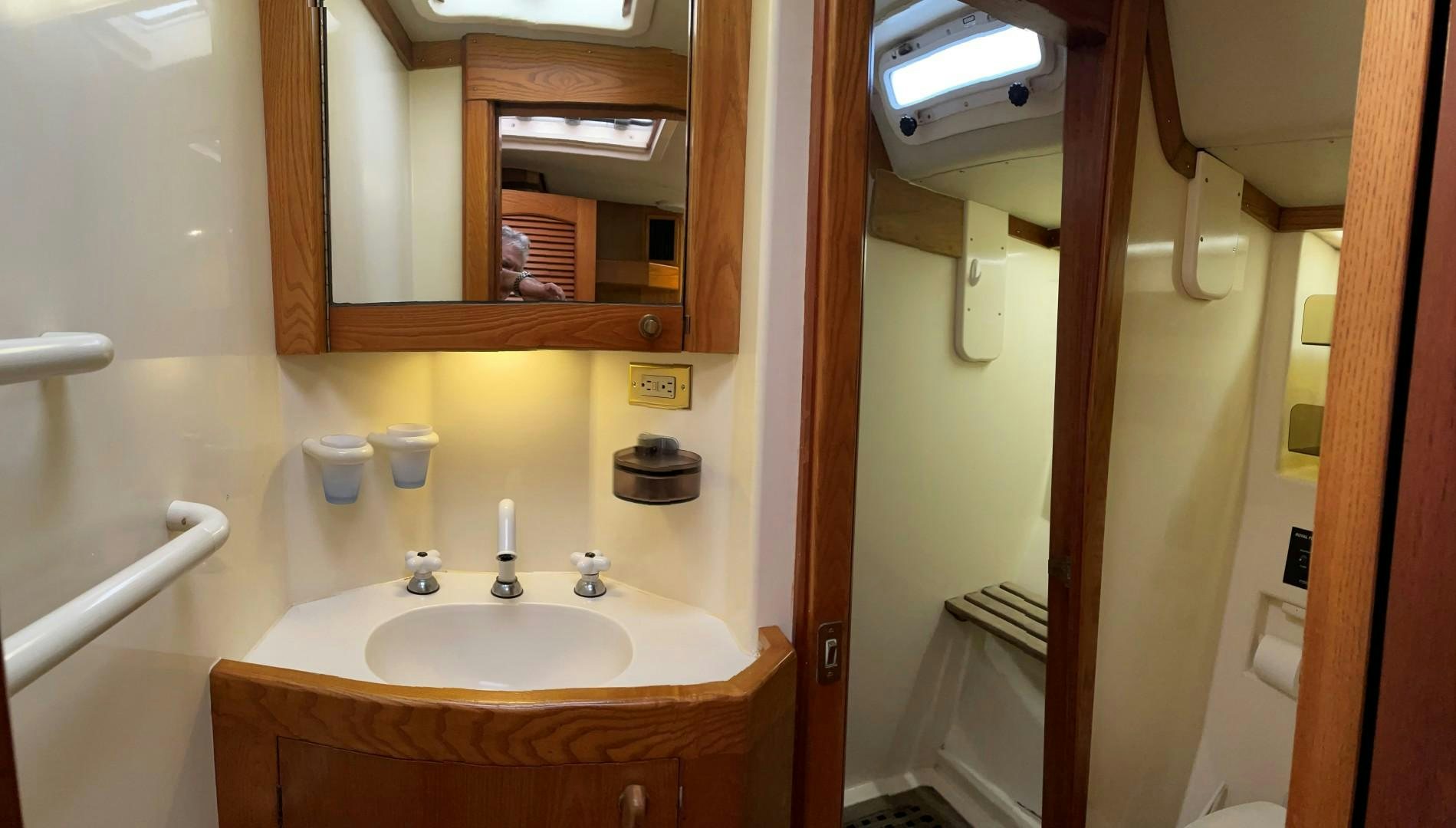 a bathroom with a sink and a mirror aboard DANCES WITH WOLVES Yacht for Sale