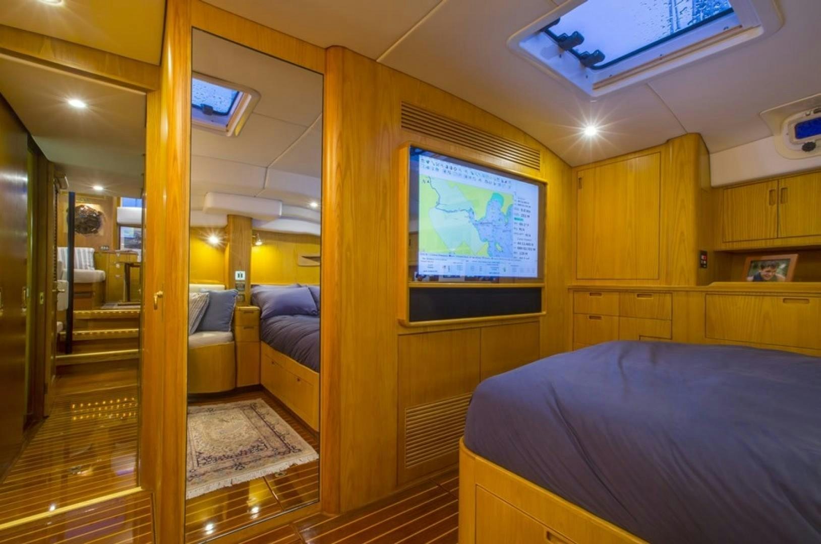 a bedroom with a wood floor aboard DANCES WITH WOLVES Yacht for Sale