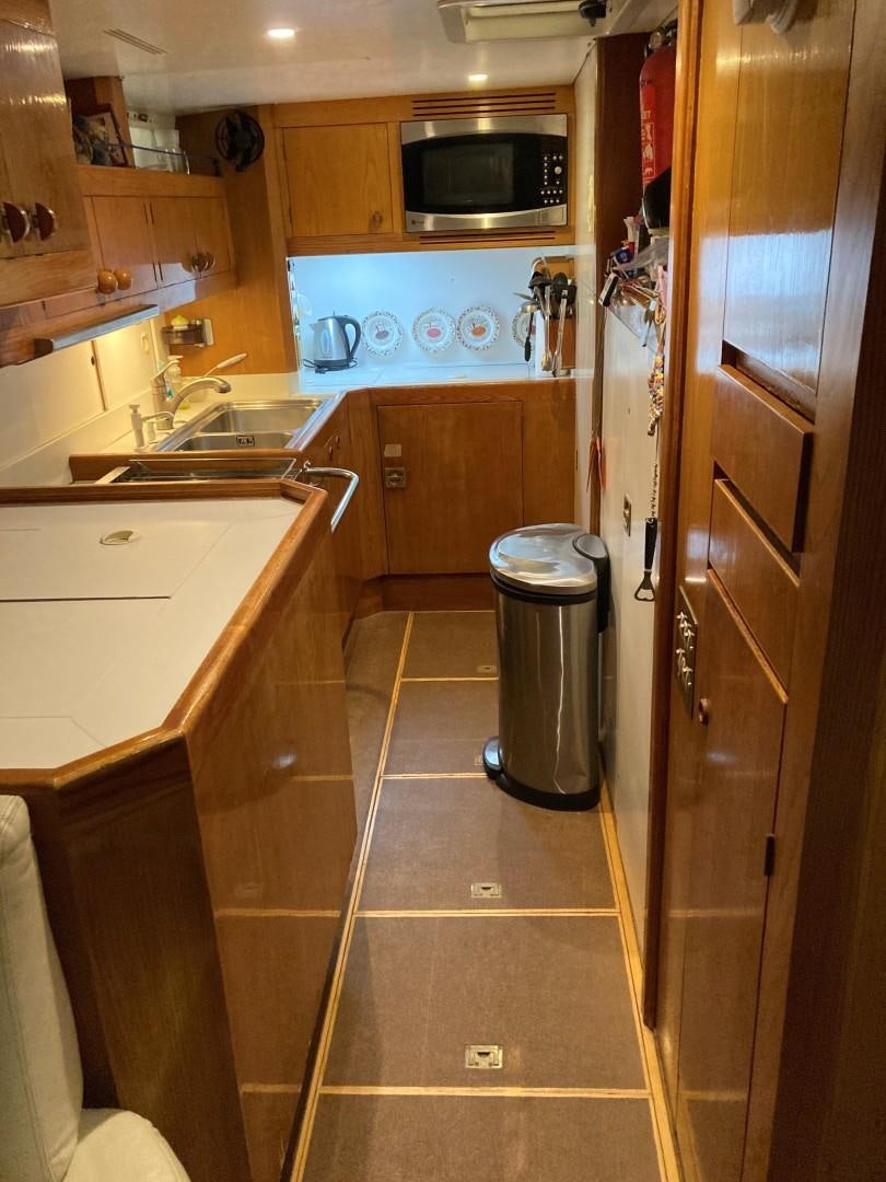 a kitchen with wooden cabinets aboard DANCES WITH WOLVES Yacht for Sale