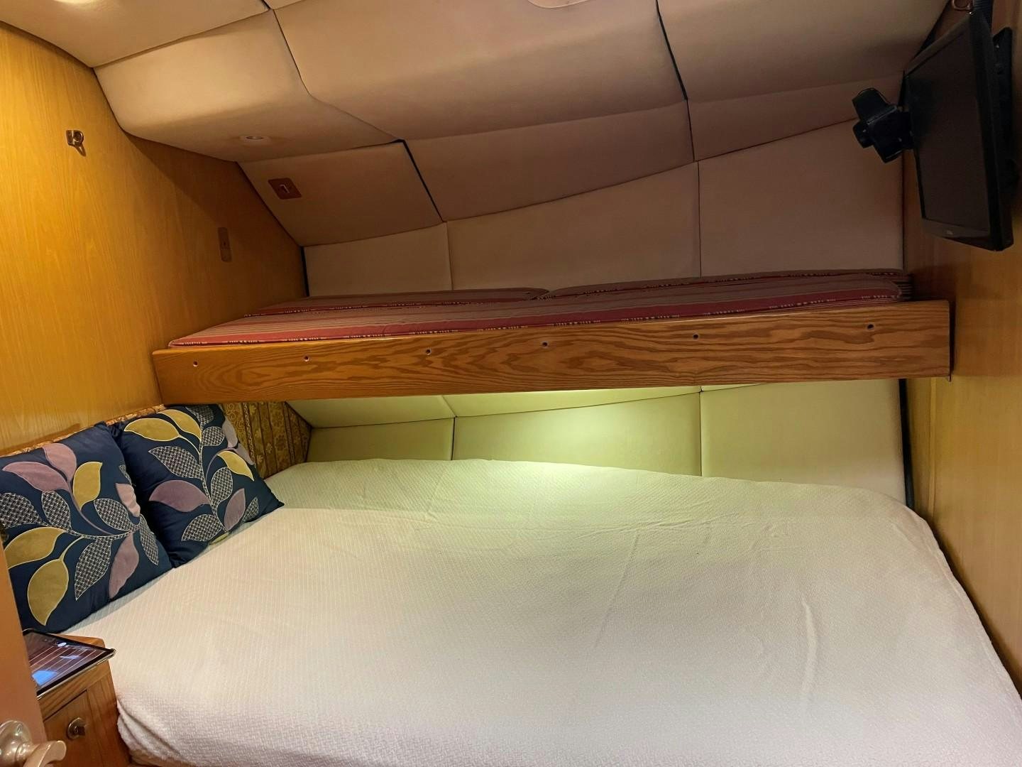 a bed with a white sheet aboard DANCES WITH WOLVES Yacht for Sale