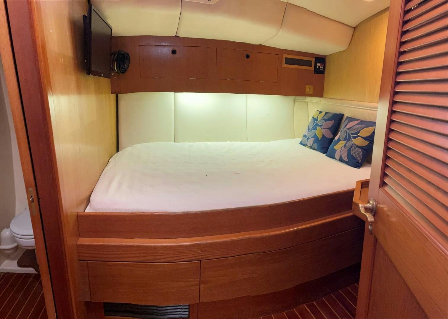 a bed with a white sheet aboard DANCES WITH WOLVES Yacht for Sale