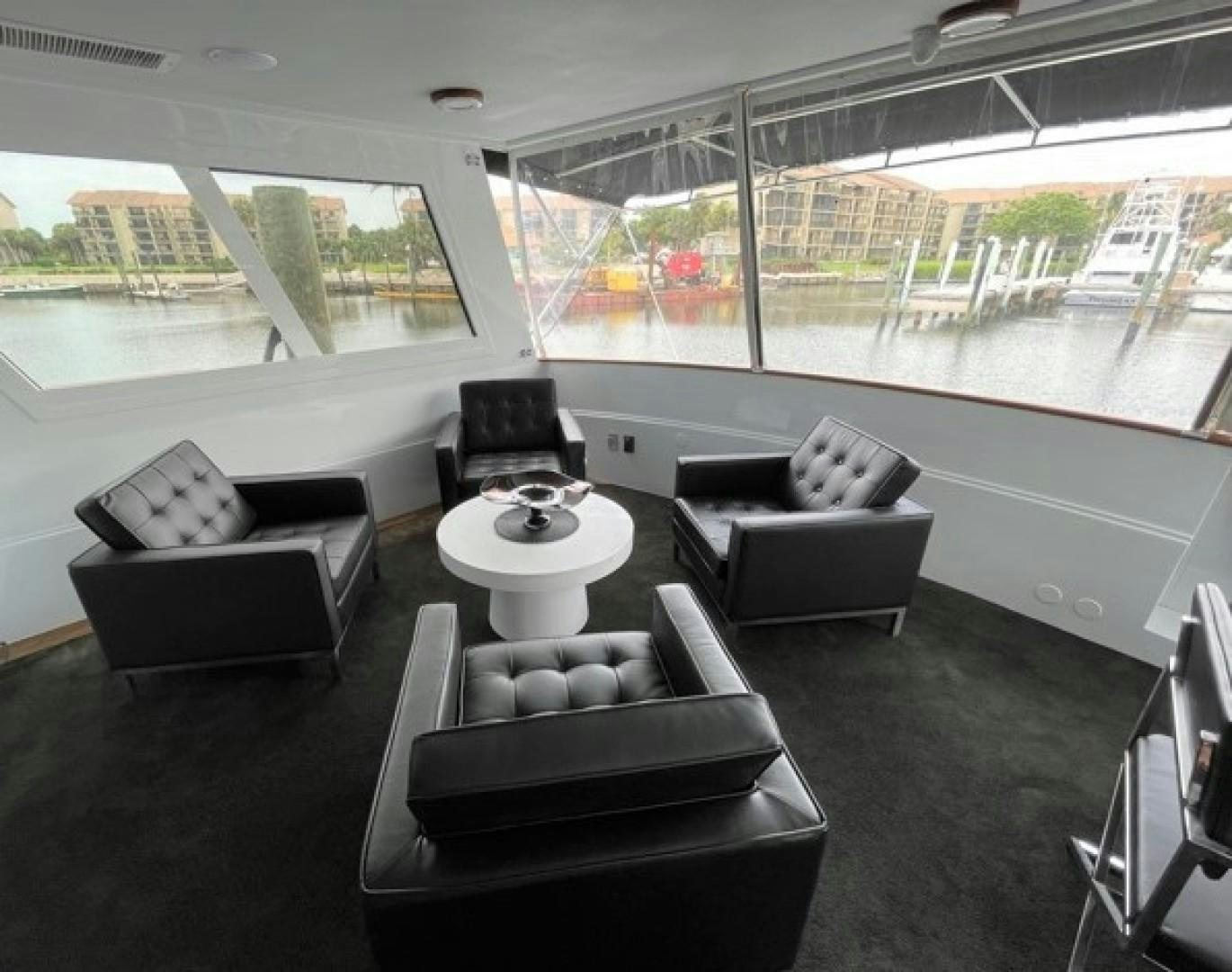 a room with couches and a table aboard MR. ED Yacht for Sale