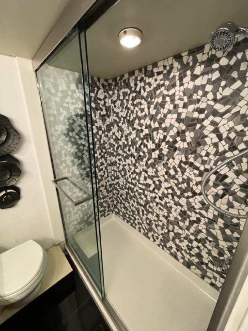 a bathroom with a shower curtain aboard MR. ED Yacht for Sale