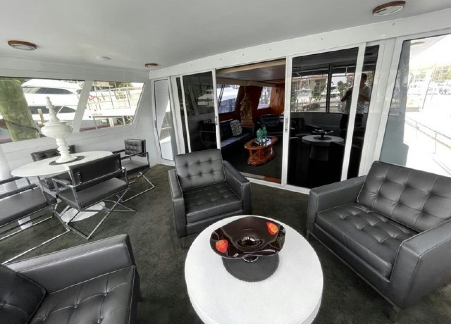 inside of a vehicle with a table and chairs and a couch aboard MR. ED Yacht for Sale