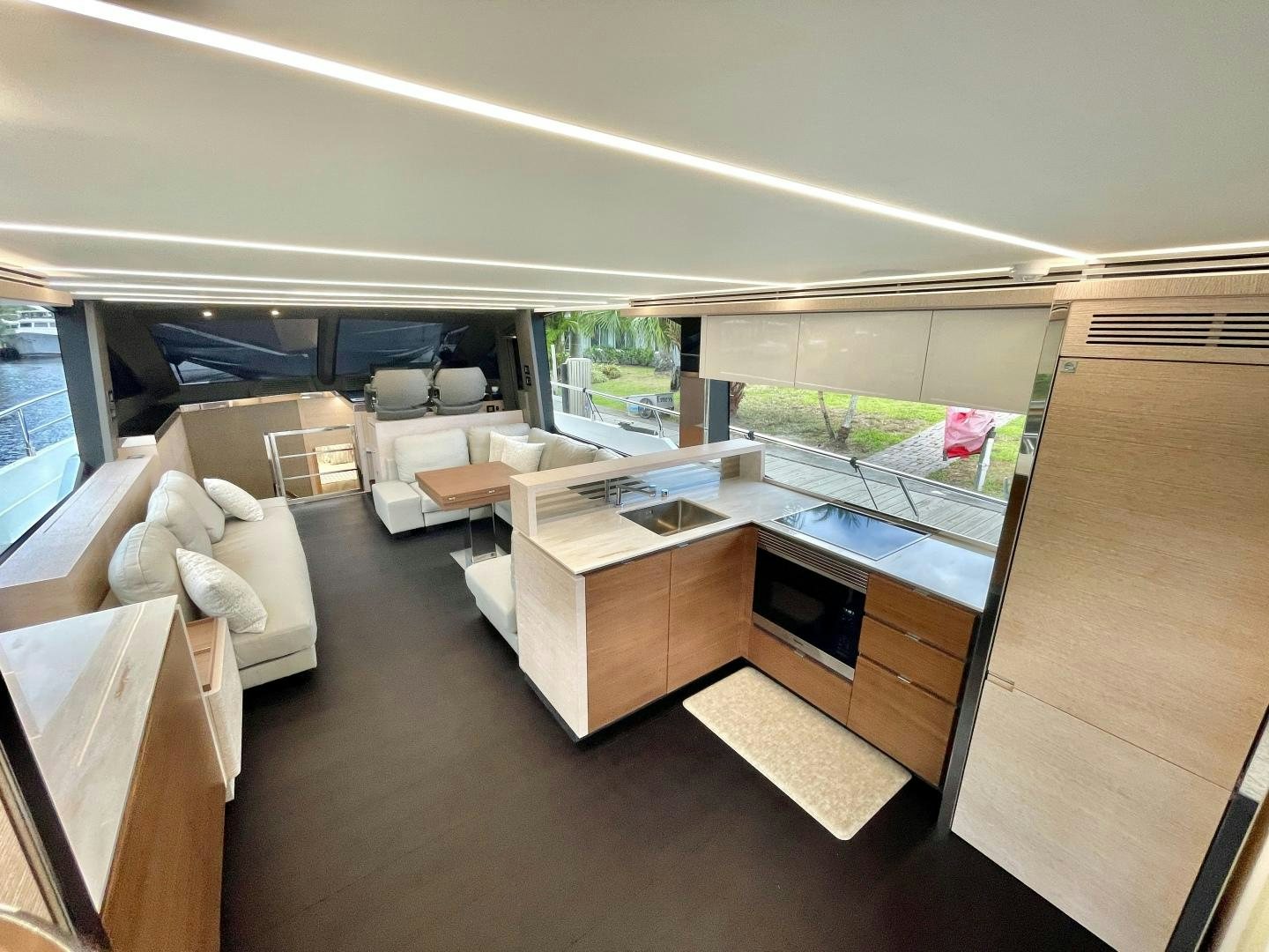 a room with a large window and a table with chairs aboard AGRODOLCE Yacht for Sale