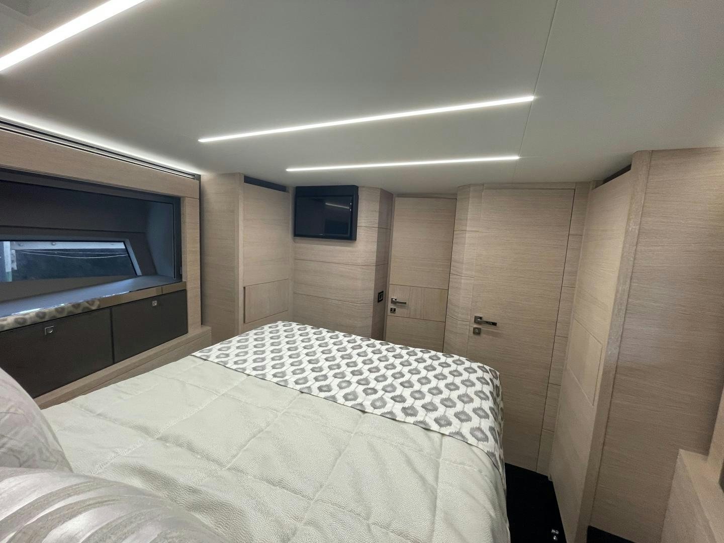 a room with a bed and a television aboard AGRODOLCE Yacht for Sale