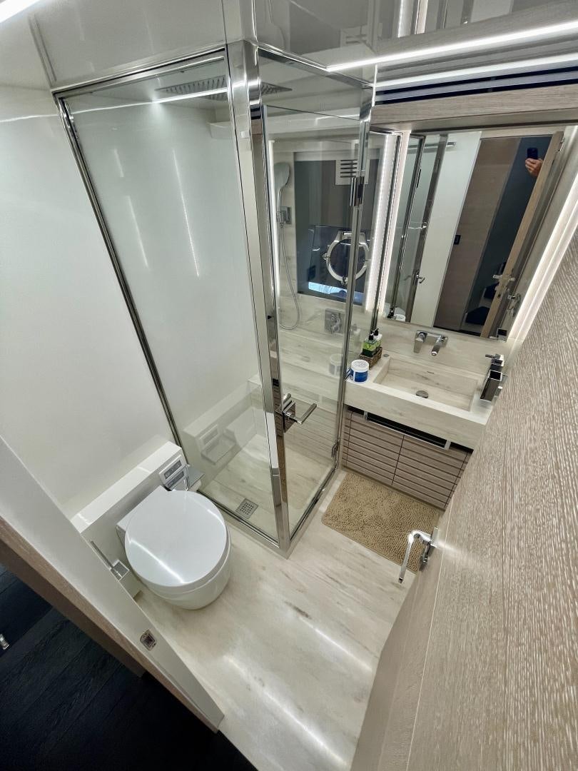 a bathroom with a glass shower aboard AGRODOLCE Yacht for Sale