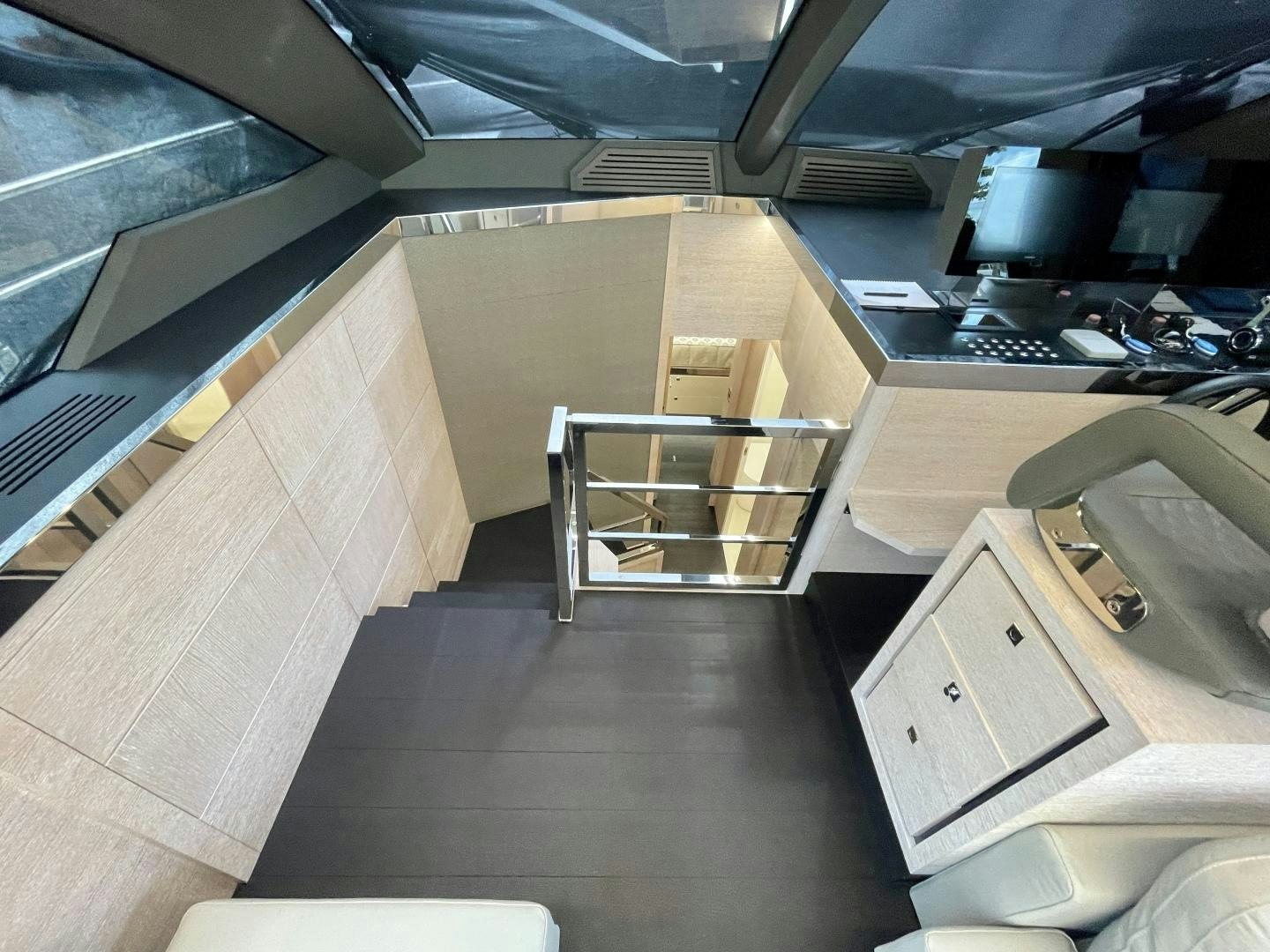 a room with a desk and a shelf with computer monitors aboard AGRODOLCE Yacht for Sale