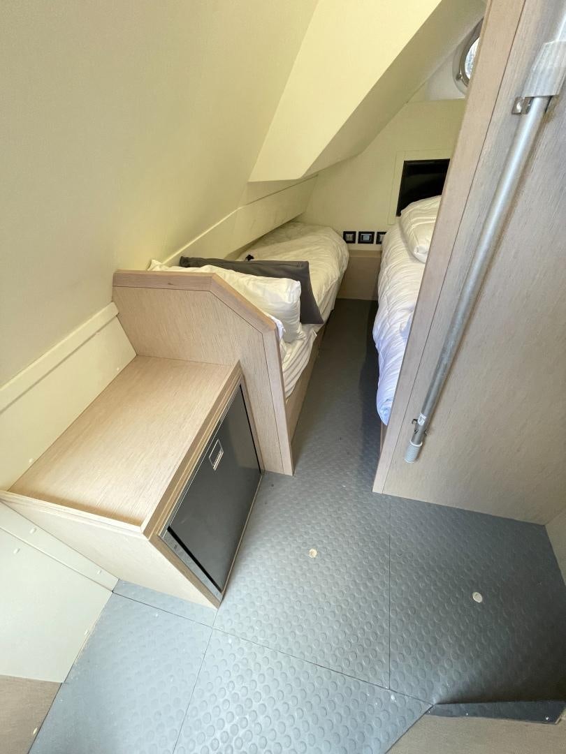 a room with a bed and a desk aboard AGRODOLCE Yacht for Sale