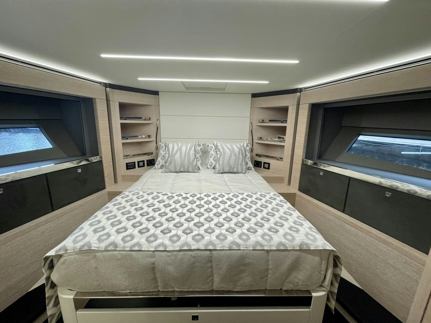 a bedroom with a bed and a bookcase aboard AGRODOLCE Yacht for Sale
