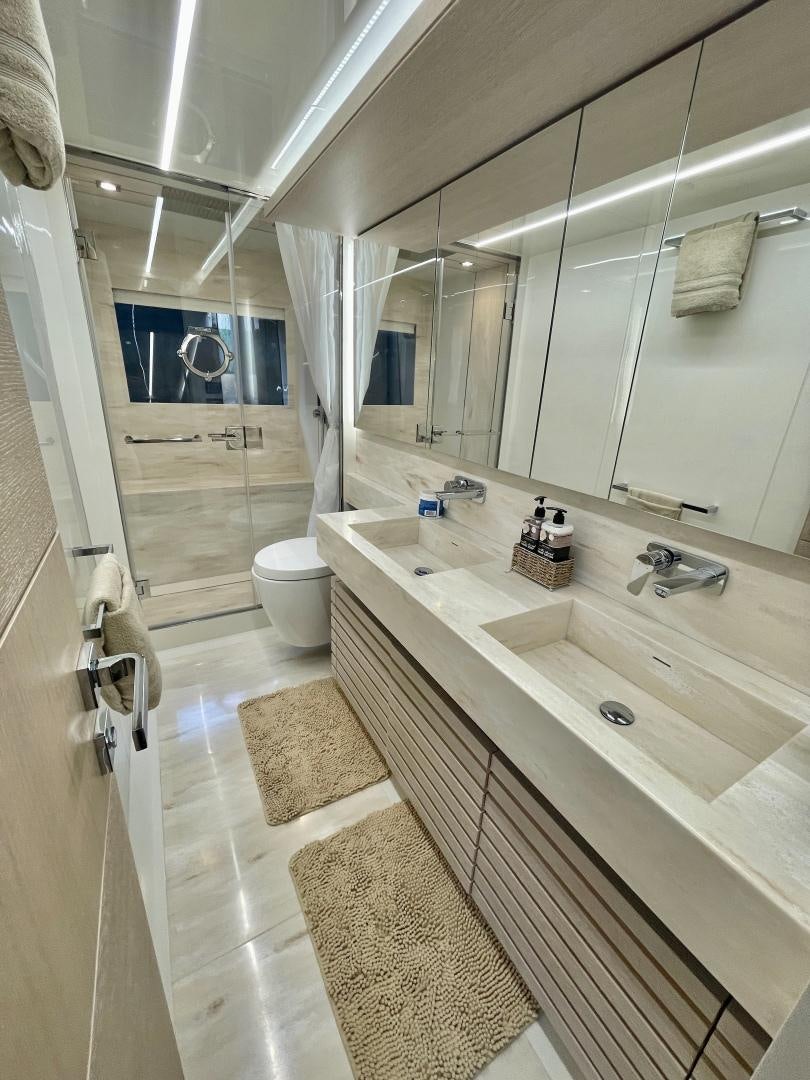 a bathroom with a large mirror aboard AGRODOLCE Yacht for Sale