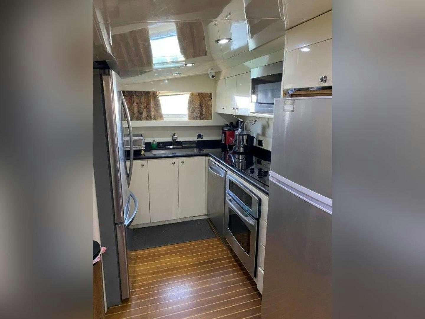 a kitchen with a fridge and a sink aboard ISLAND SEEKER Yacht for Sale