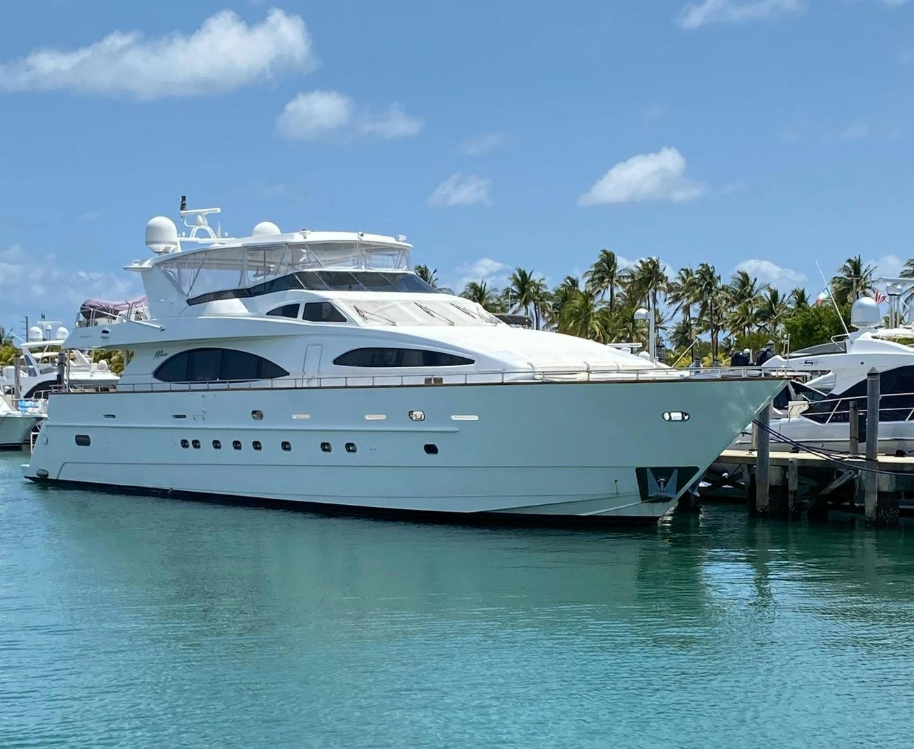 a white yacht docked at a pier aboard ISLAND SEEKER Yacht for Sale