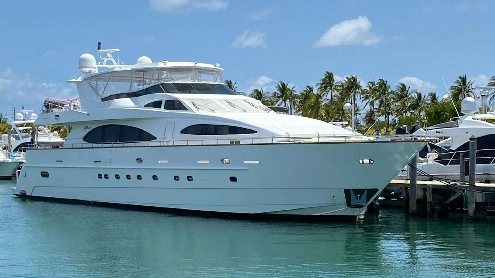 a white yacht docked at a pier aboard ISLAND SEEKER Yacht for Sale