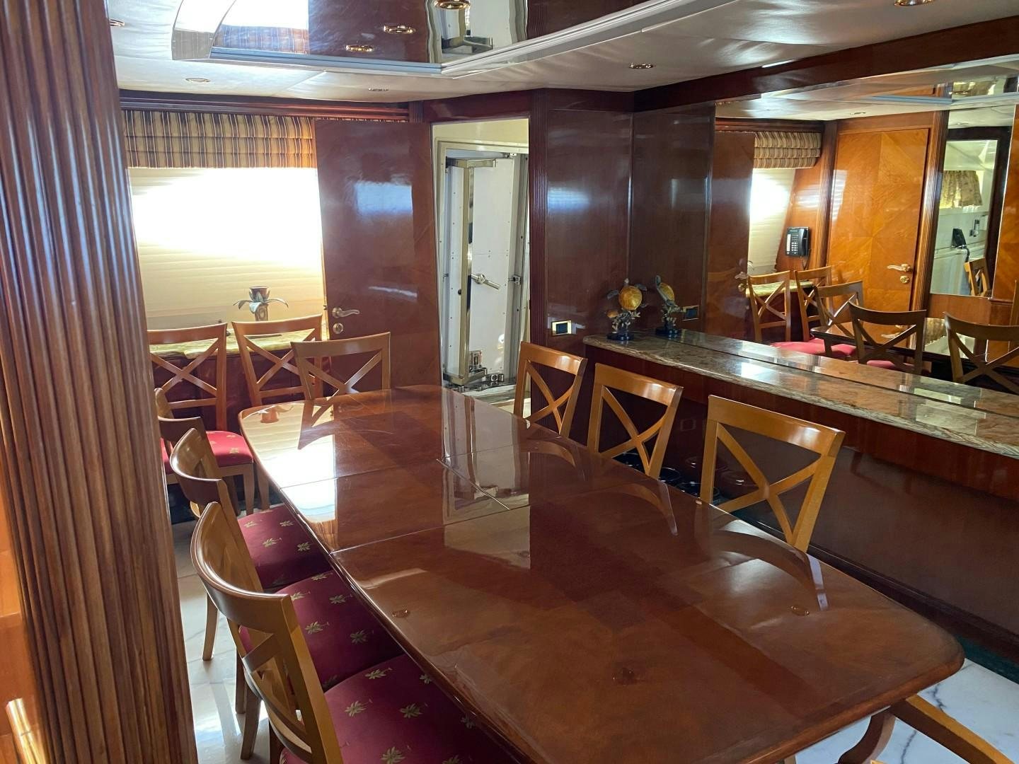 a room with tables and chairs aboard ISLAND SEEKER Yacht for Sale