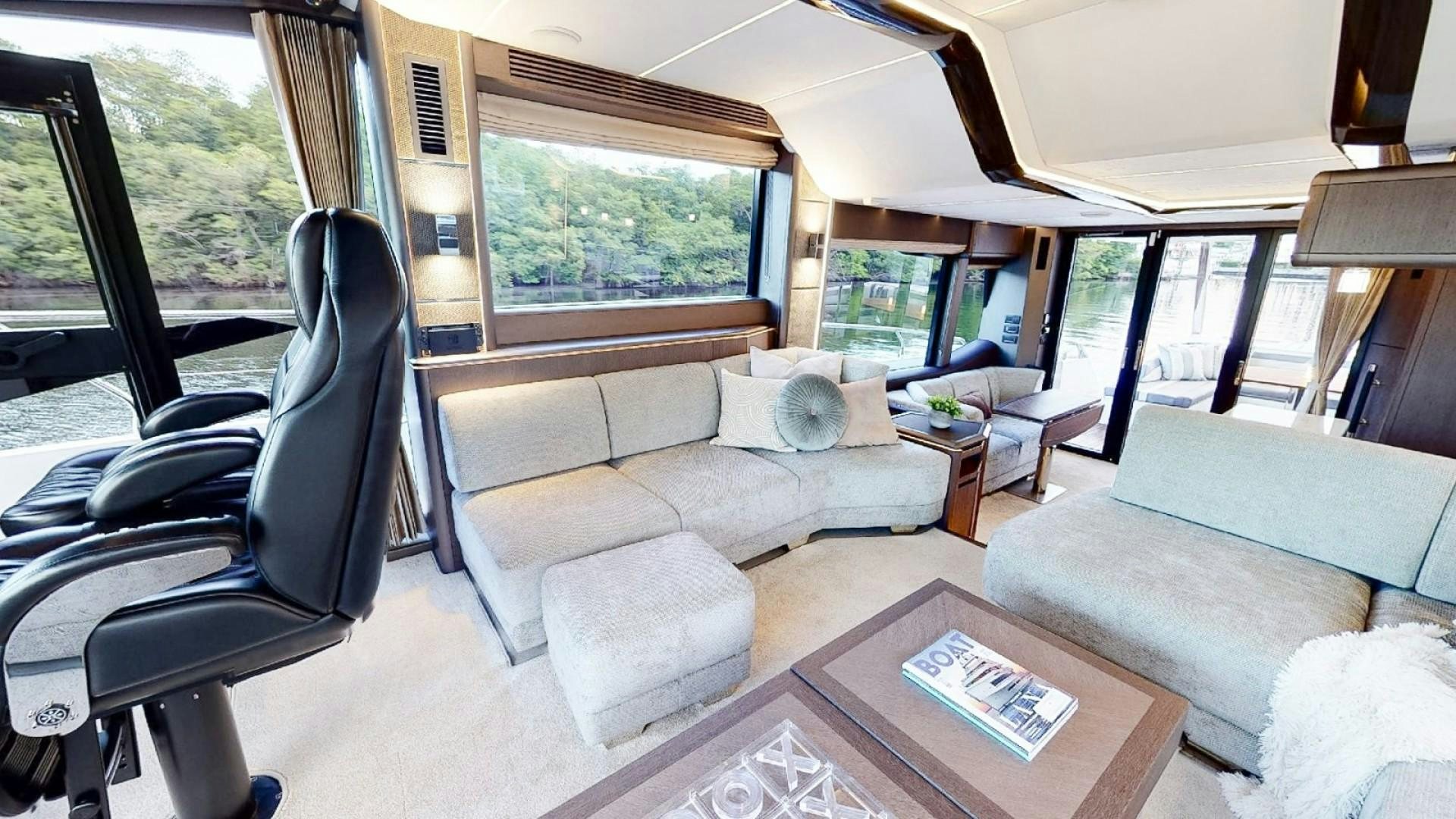 a living room with a couch and a table aboard HANG TIME Yacht for Sale