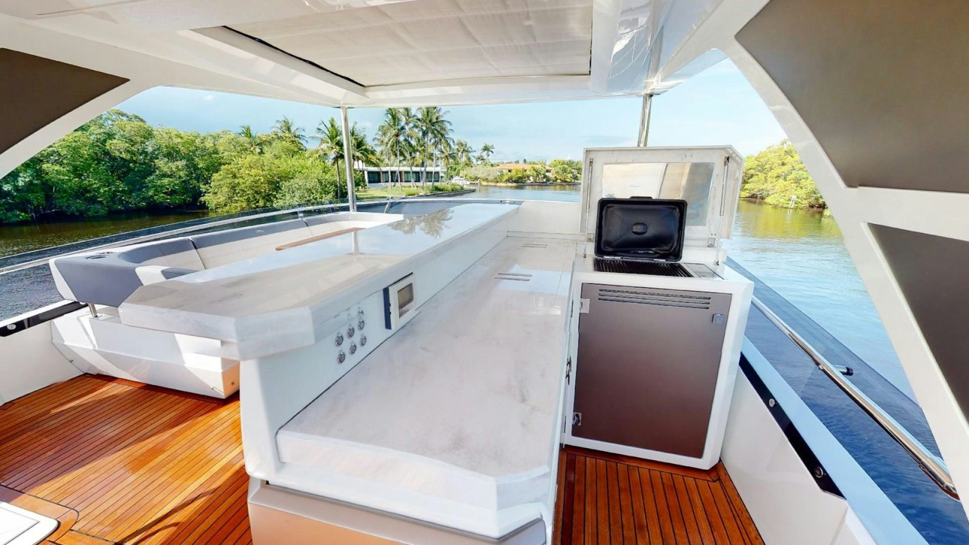 a room with a large white counter and a microwave oven aboard HANG TIME Yacht for Sale