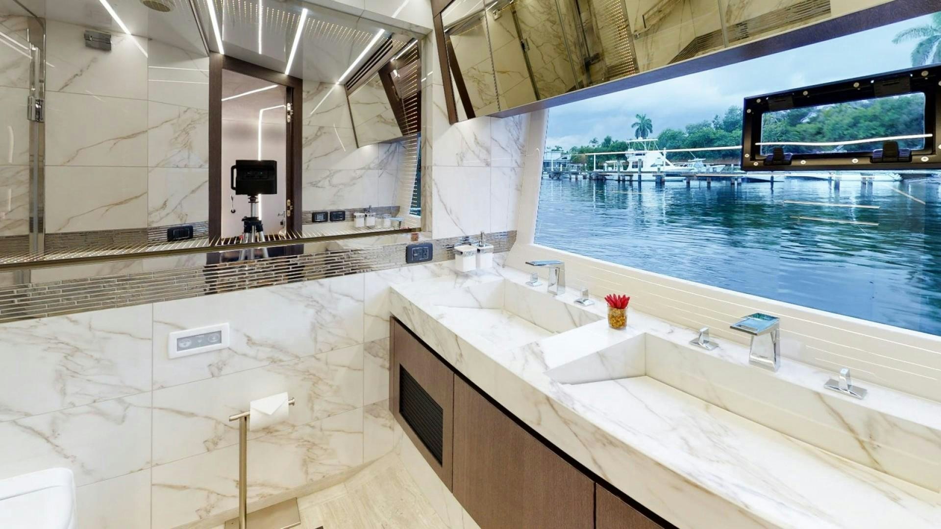 a bathroom with a large window aboard HANG TIME Yacht for Sale