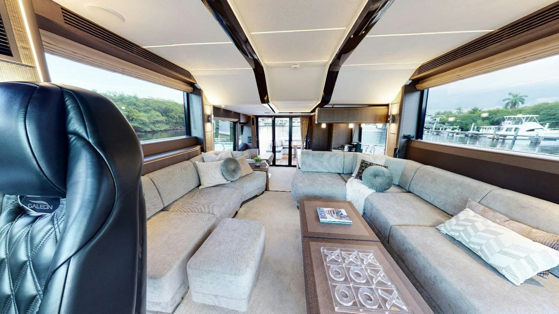 a living room with a couch and a coffee table aboard HANG TIME Yacht for Sale
