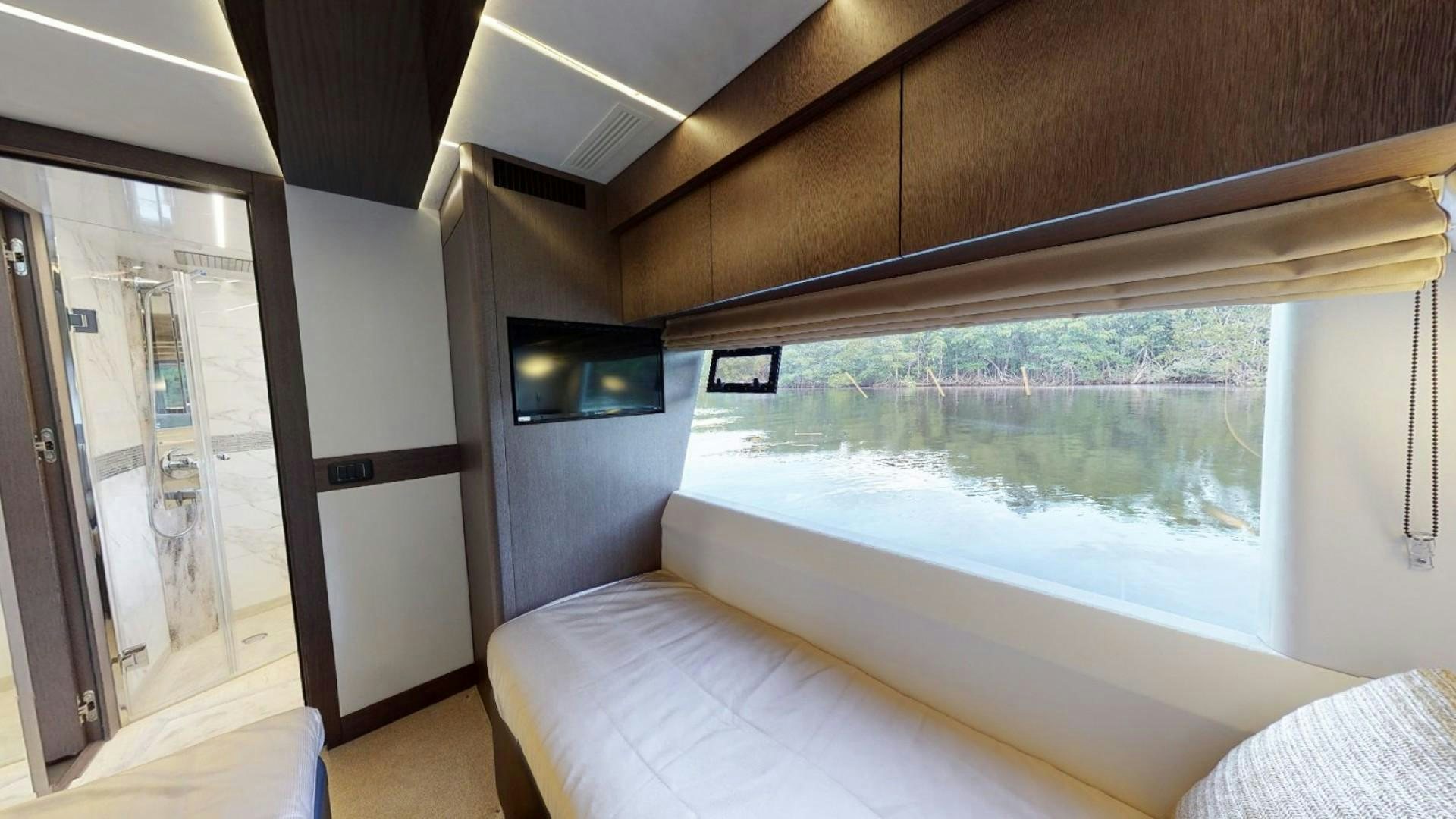 a room with a bed and a television aboard HANG TIME Yacht for Sale