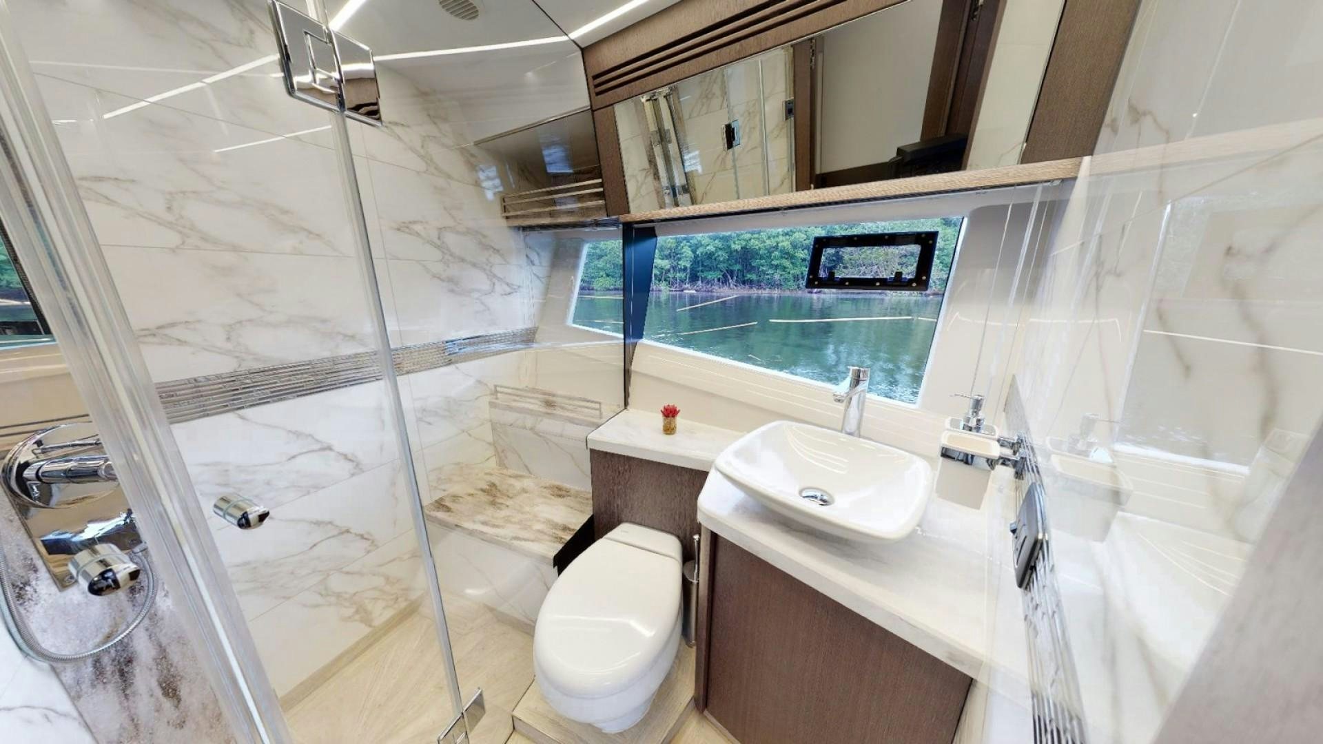 a bathroom with a glass shower aboard HANG TIME Yacht for Sale