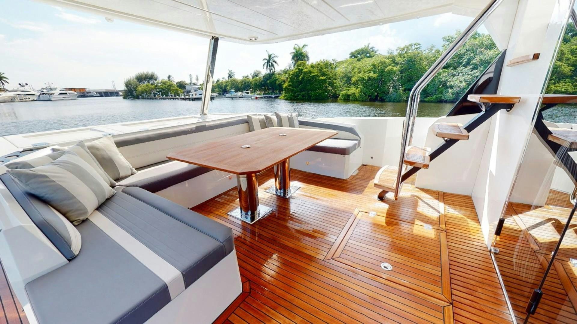 a room with a table and chairs aboard HANG TIME Yacht for Sale