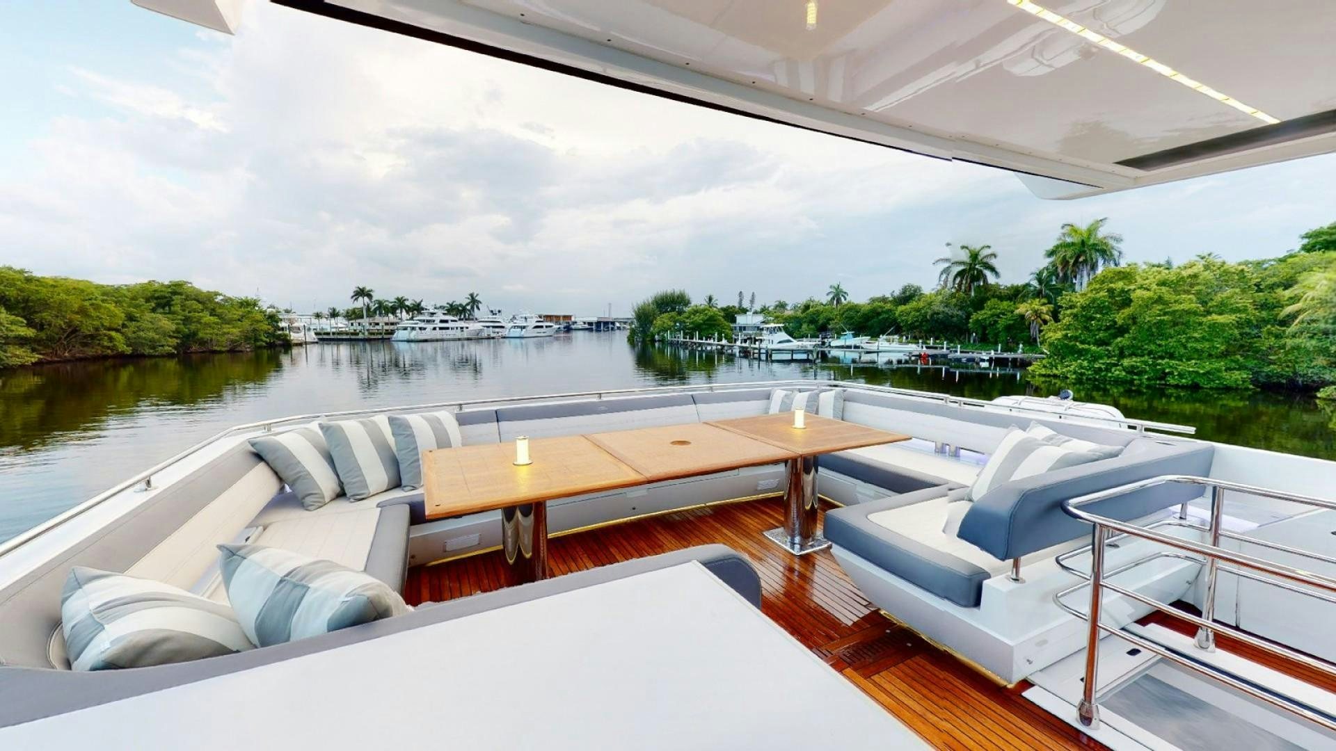 a large lounge area with a large pool and a view of a city aboard HANG TIME Yacht for Sale