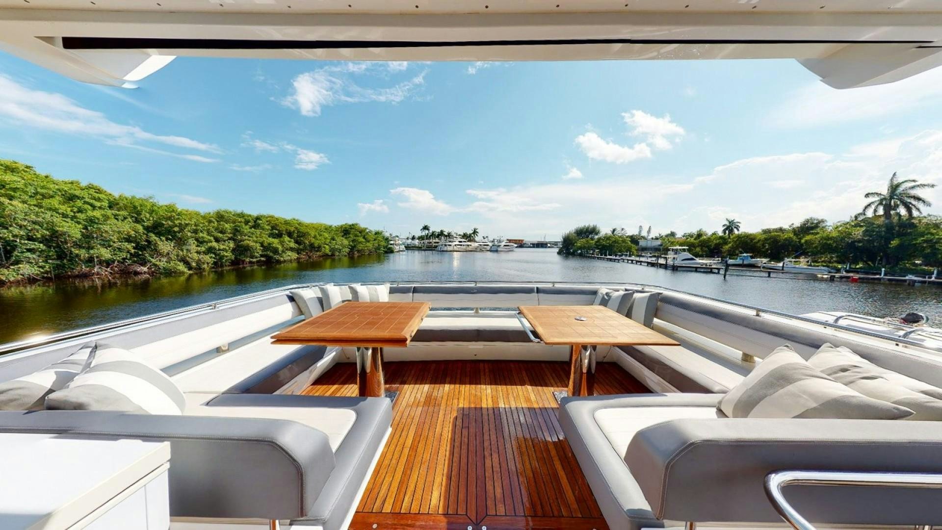 a deck with chairs and tables on it aboard HANG TIME Yacht for Sale