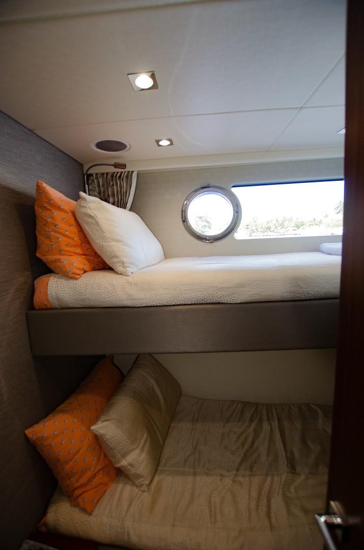 a bed with orange pillows aboard No Name Yacht for Sale