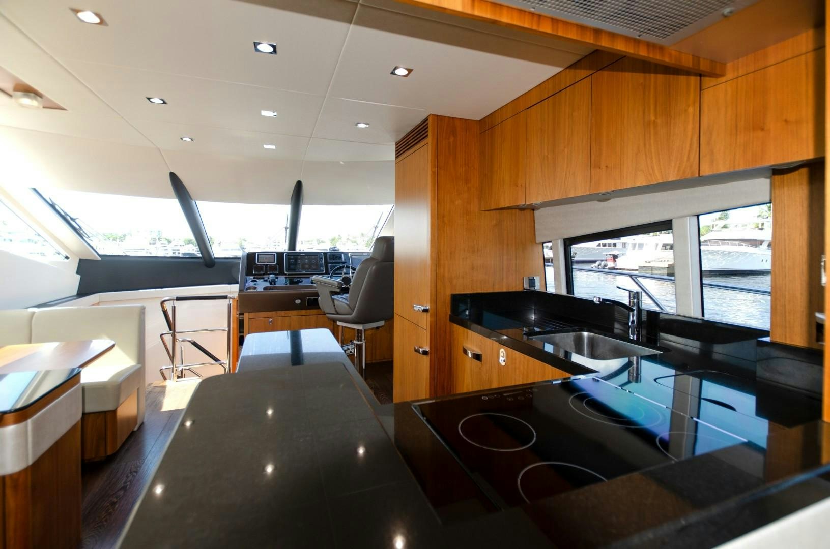 a room with a large window and a table with chairs aboard No Name Yacht for Sale