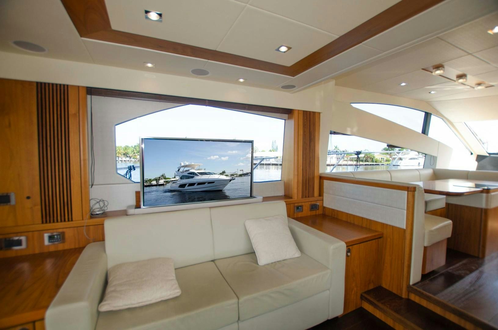 a room with a couch and a television aboard No Name Yacht for Sale
