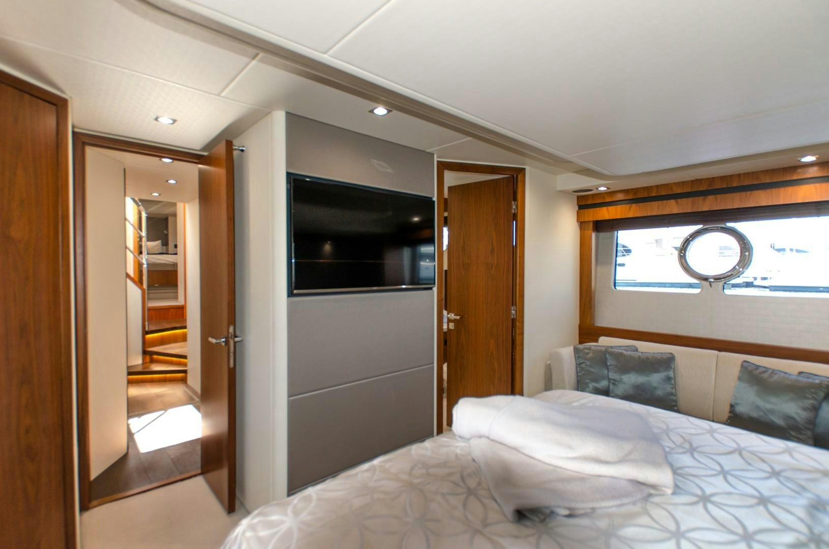 a bedroom with a bed and a door aboard No Name Yacht for Sale