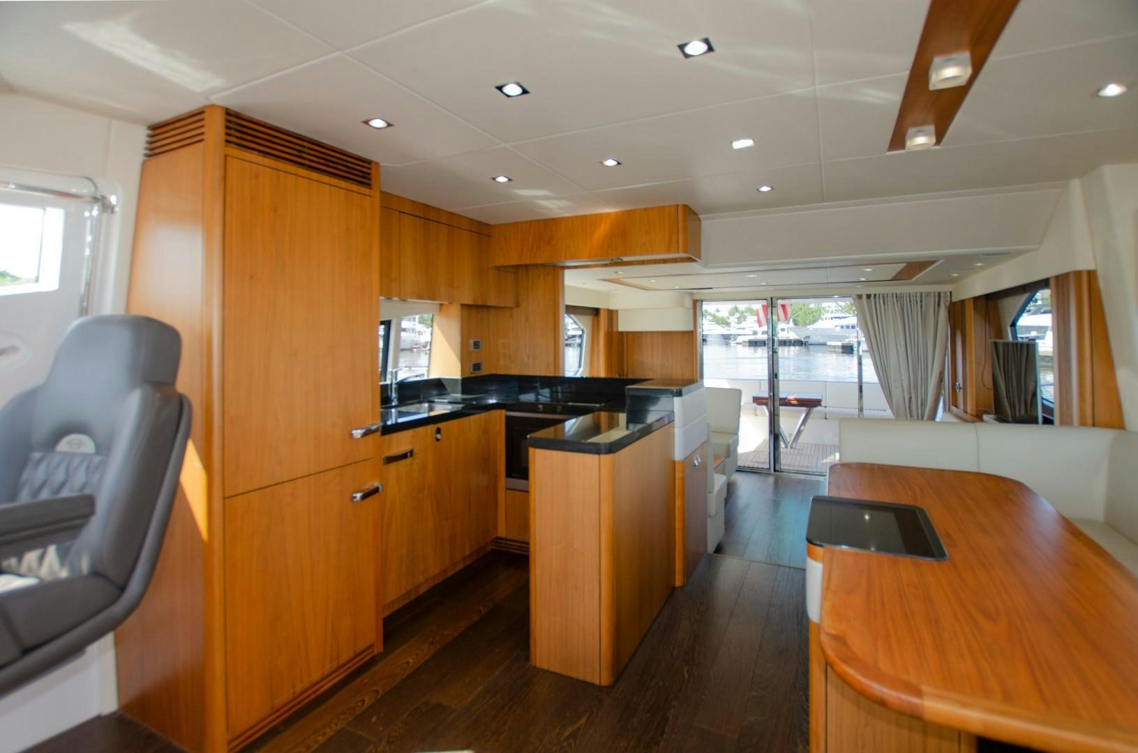 a kitchen with a table and chairs aboard No Name Yacht for Sale
