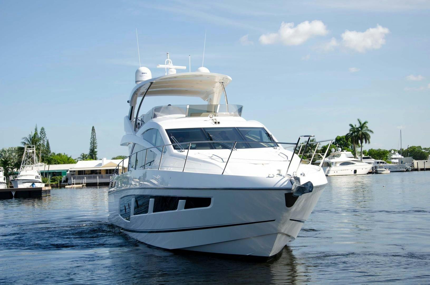 a white yacht in a harbor aboard No Name Yacht for Sale