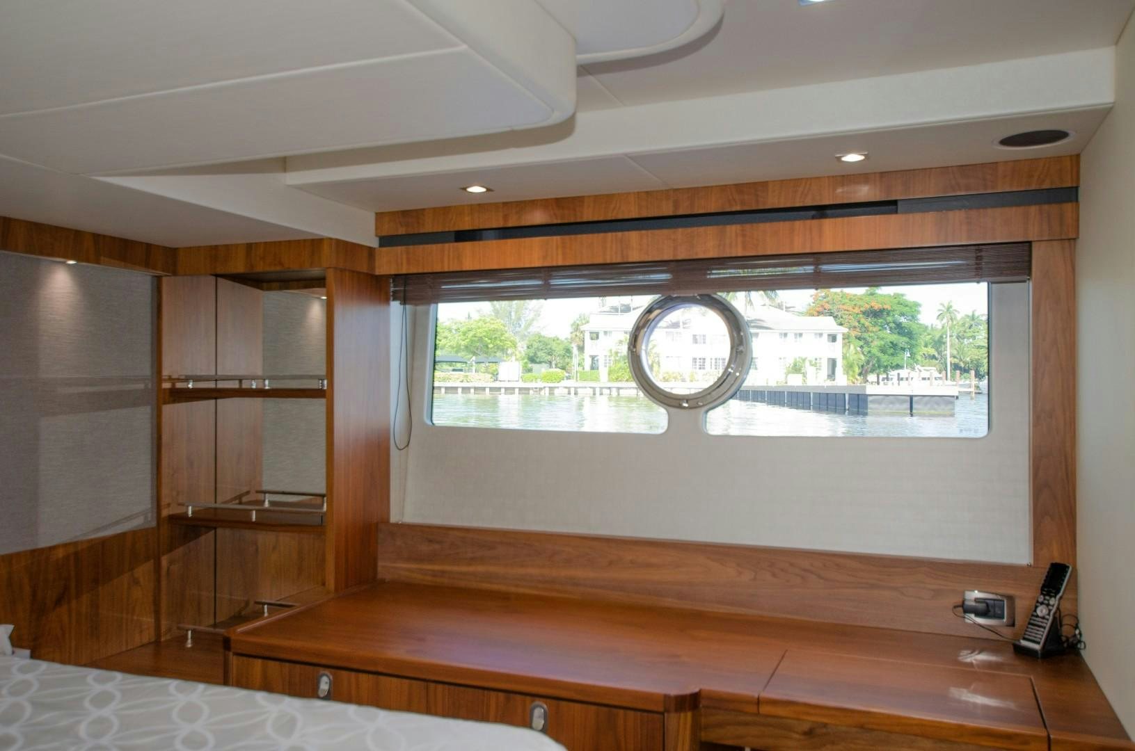 a room with a wood shelf and a clock on the wall aboard No Name Yacht for Sale