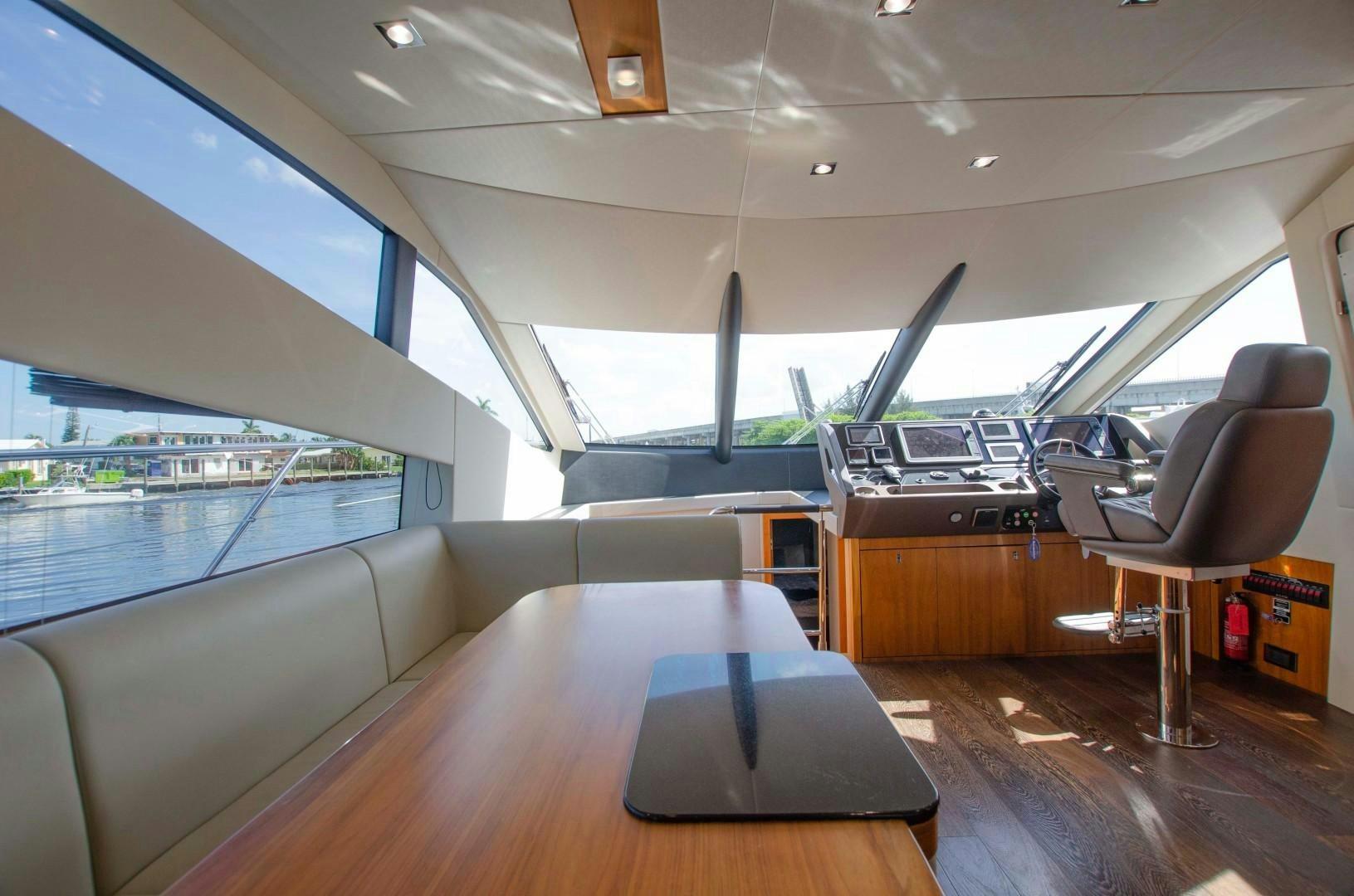 a room with a large window and a table with chairs aboard No Name Yacht for Sale
