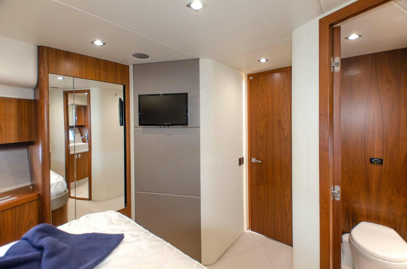 a bedroom with a bed and a television aboard No Name Yacht for Sale