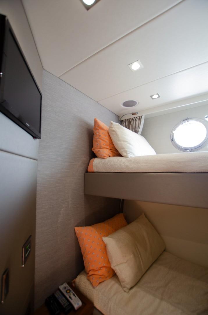 a bed with orange pillows aboard No Name Yacht for Sale