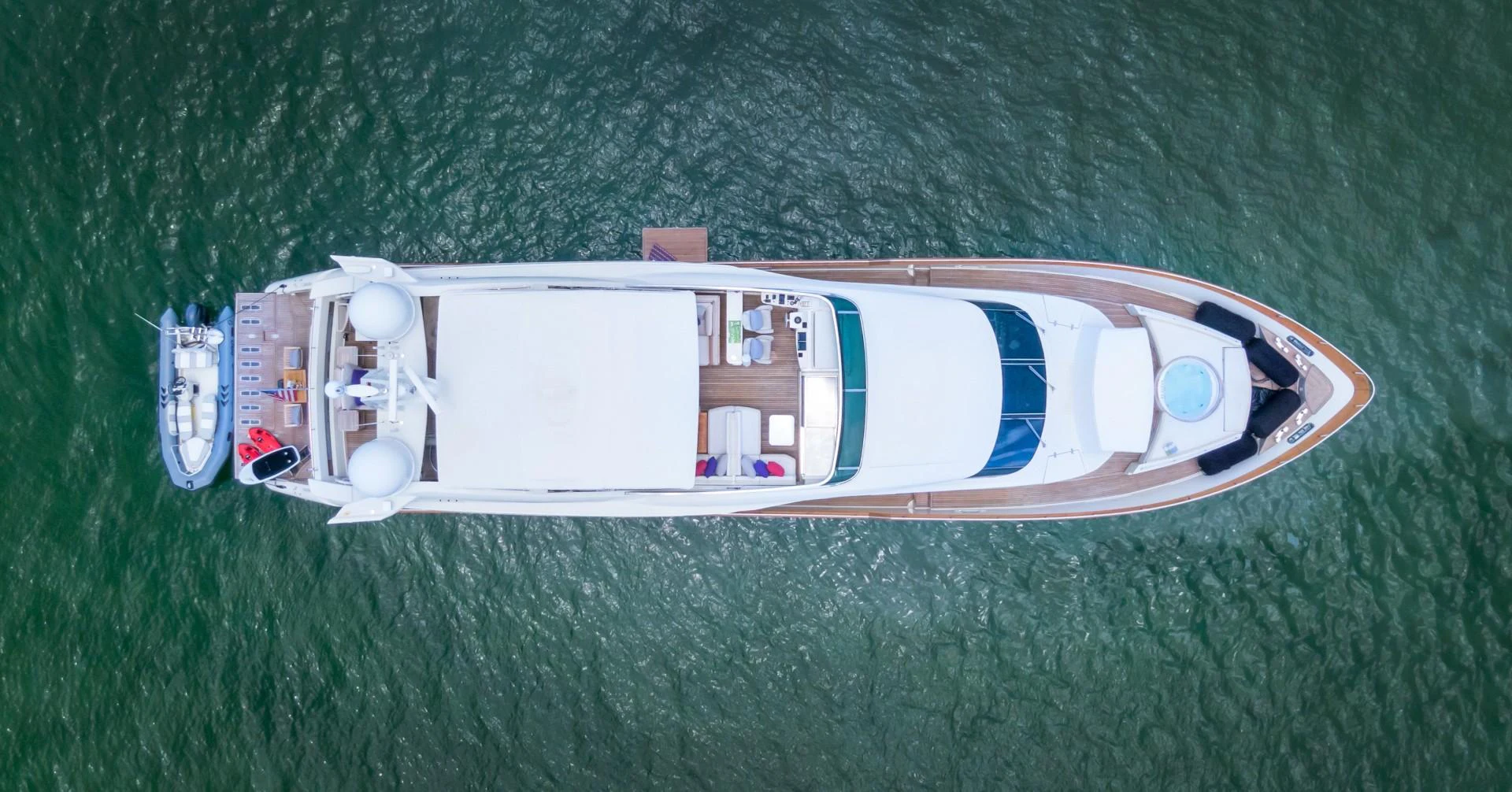 a small boat on a green lawn aboard CASUAL Yacht for Sale