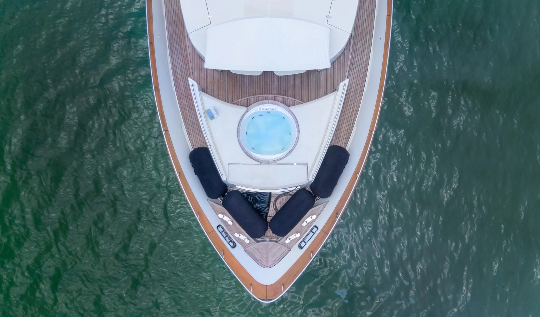a small wooden boat in the water aboard CASUAL Yacht for Sale