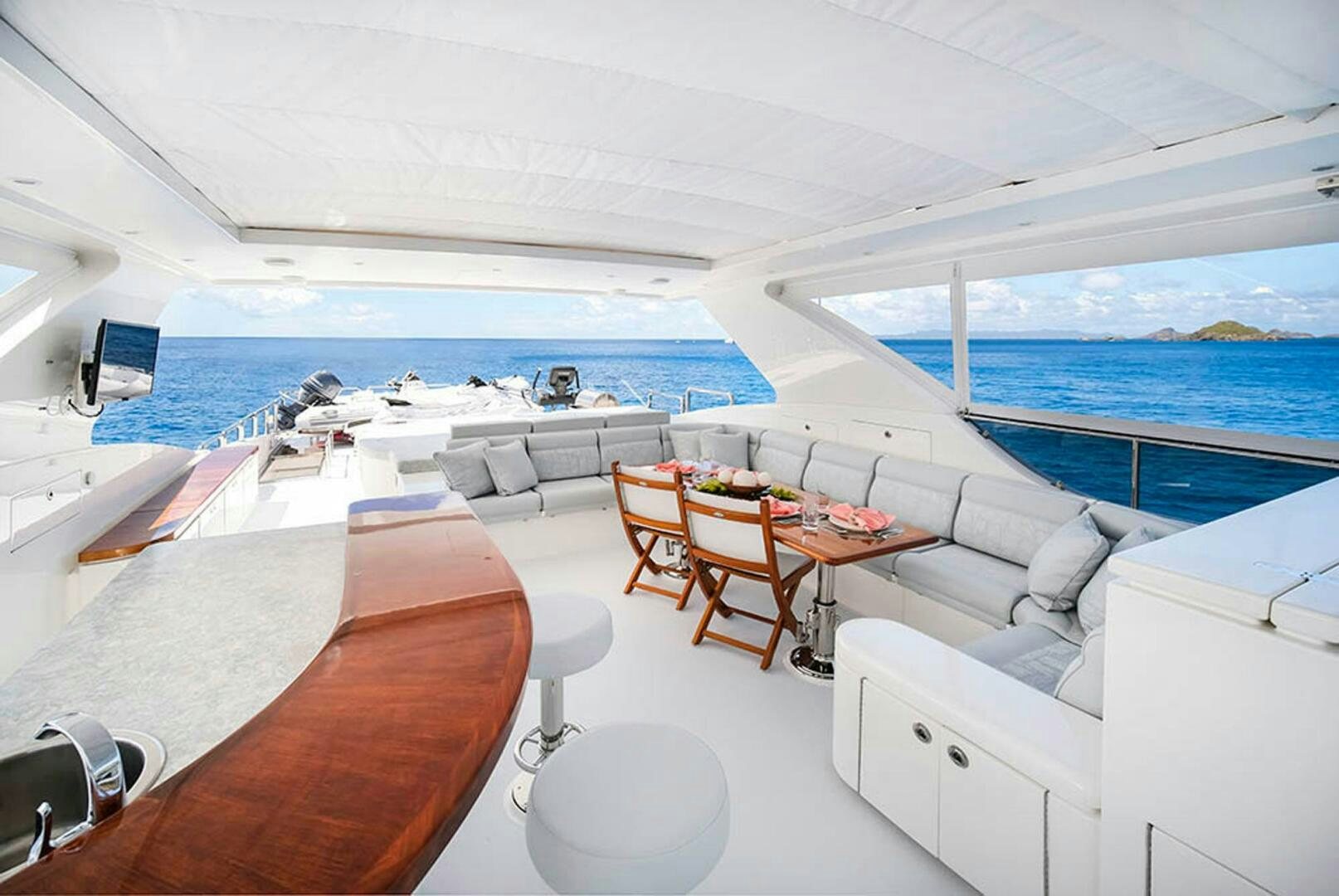 a room with a bed and a table and chairs aboard CYNDERELLA Yacht for Sale