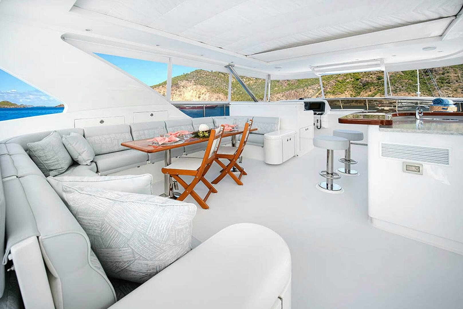 a room with a couch and a table and chairs aboard CYNDERELLA Yacht for Sale