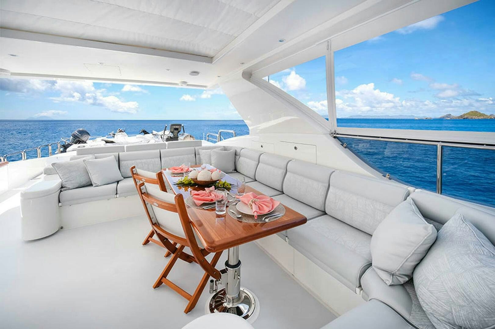 a table and chairs on a deck aboard CYNDERELLA Yacht for Sale