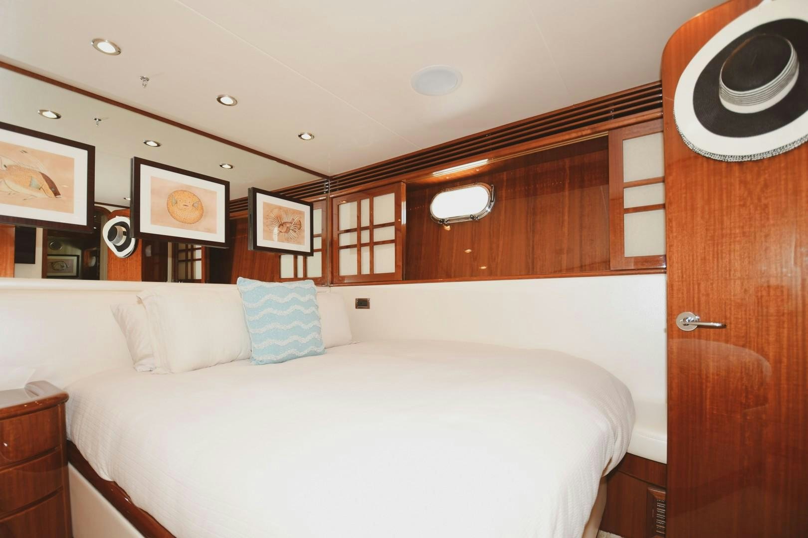 a bed with white sheets and pillows aboard WARHORSE Yacht for Sale